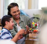 Woman teacher interacting with boy student.